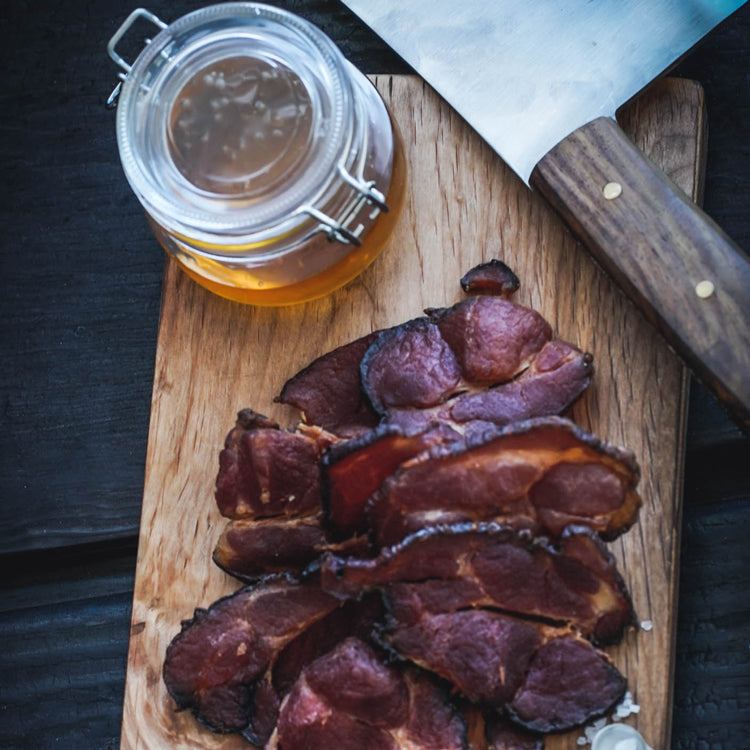 Cutting board full of Butcher's Cut Bacon and Honey