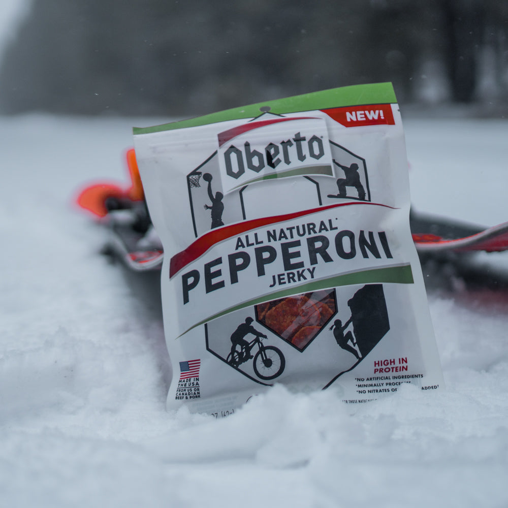 Pepperoni Jerky resting against snow skis 
