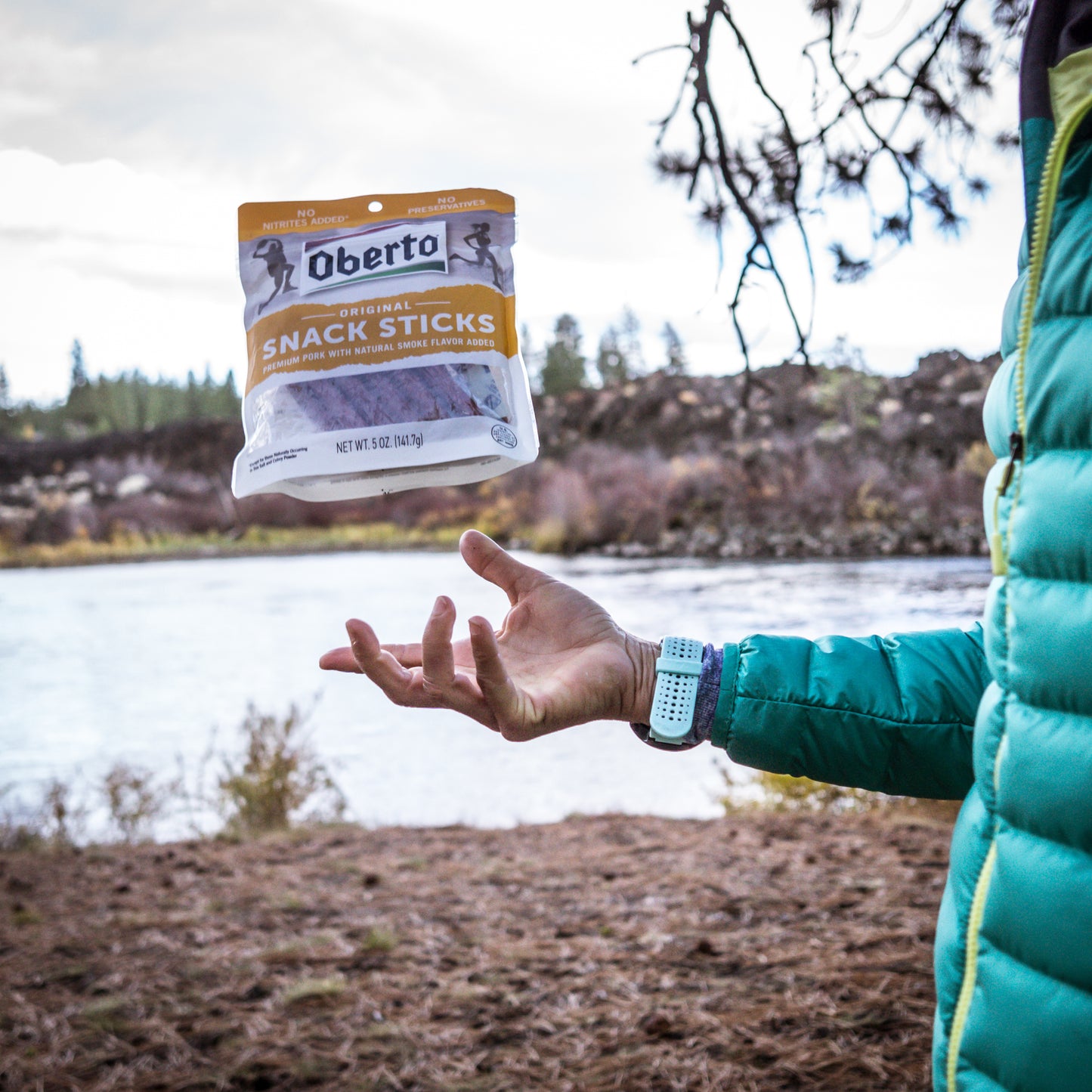 hiker tossing meat sticks in the air 