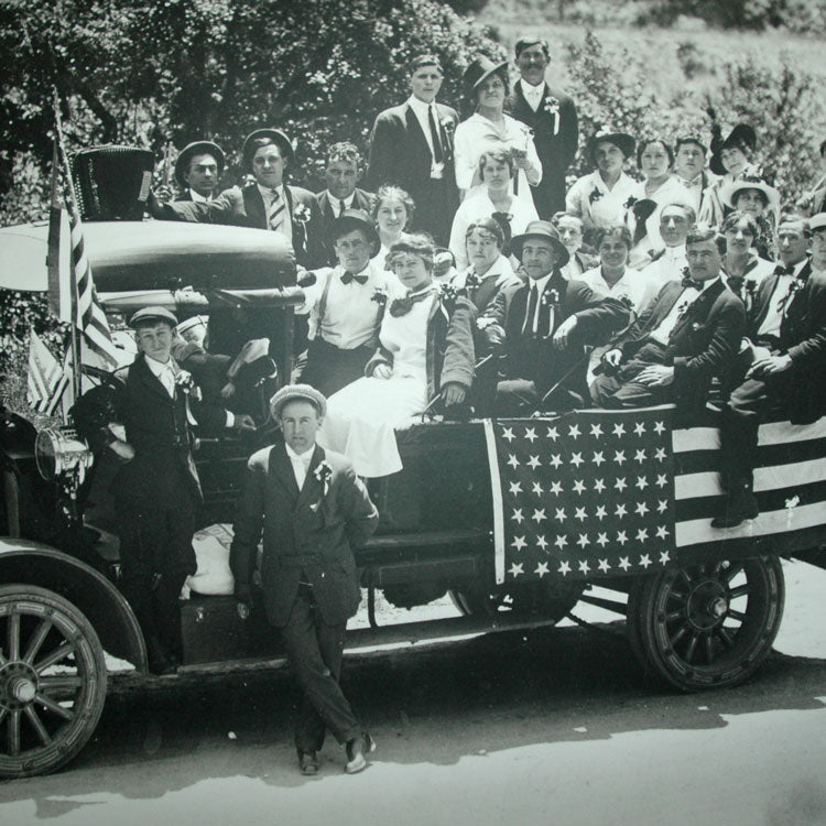 The Oberto family enjoys a 1930's 4th of July parade riding in a Model T truck.  