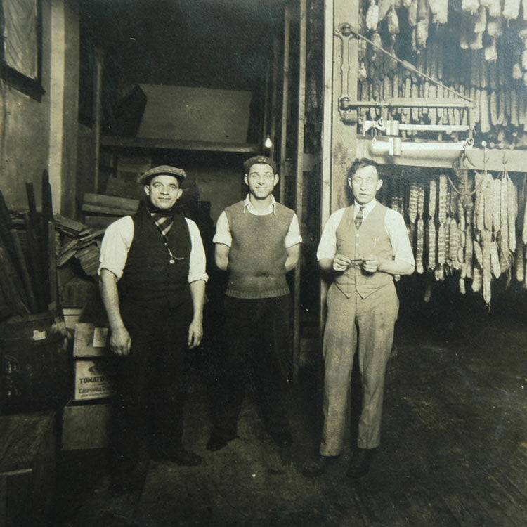 Constantino Oberto and two friends standing in the first Oberto Speciality MeatsFactory. 