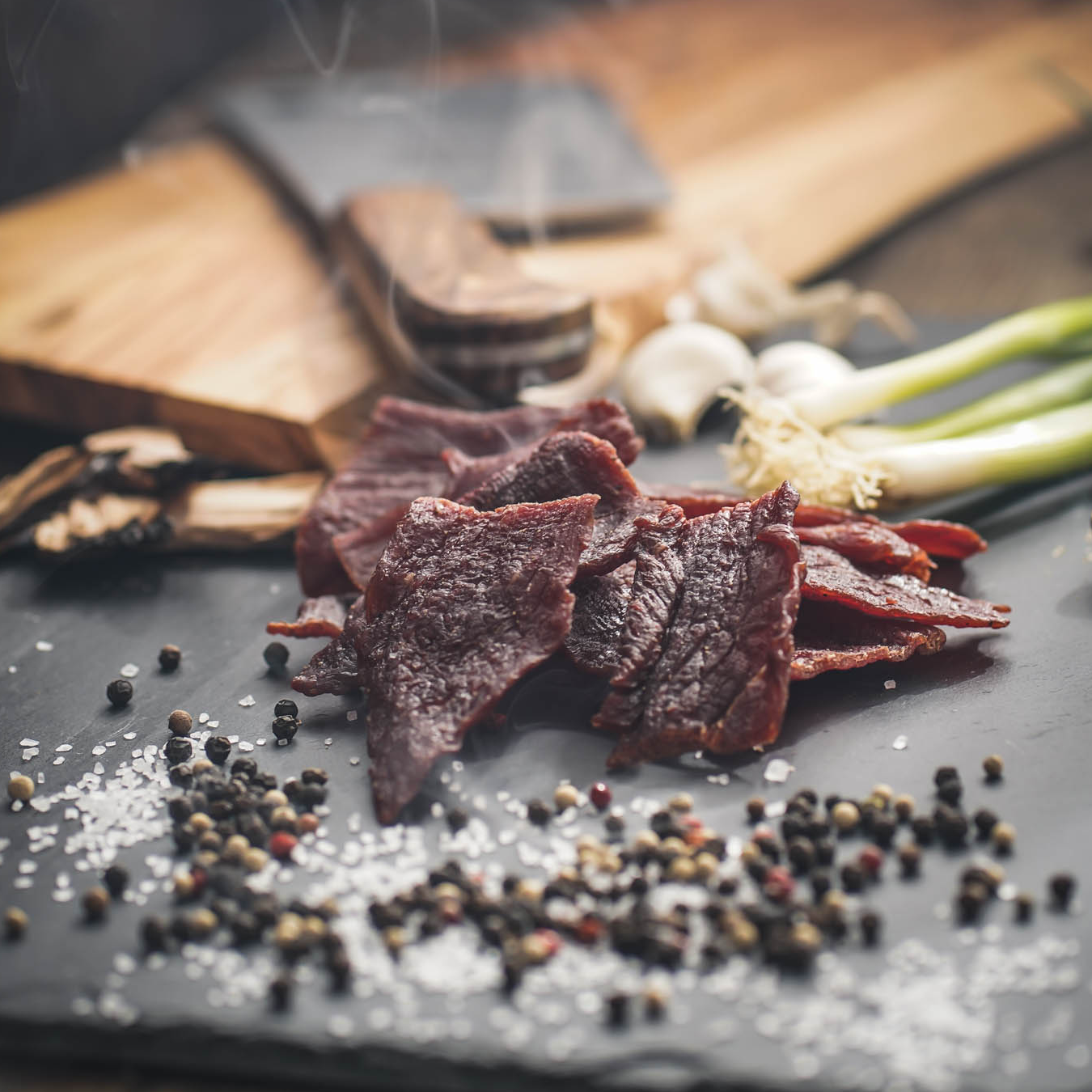 Oberto Beef Jerky and ingredients resting on a slate surface